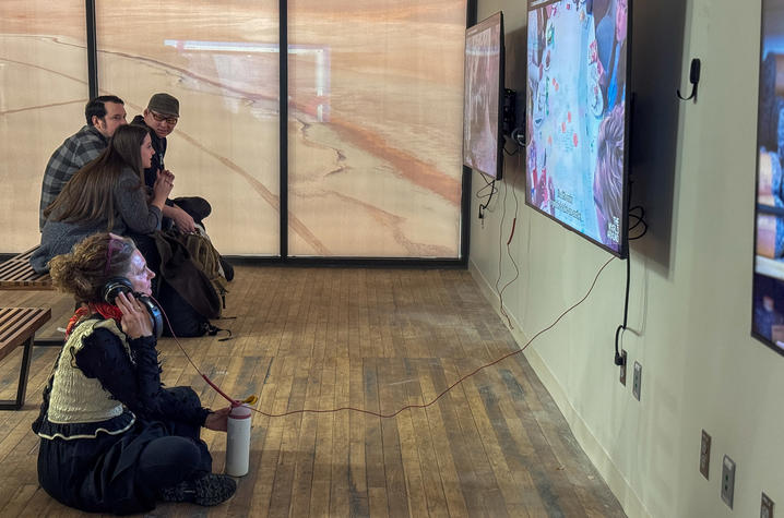 visitors view digital boards in a gallery