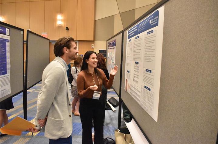 attendees looking at a poster during Markey Research Day