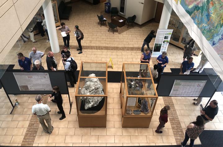 Students, faculty, staff and guests gather in the MMRB atrium to view research posters