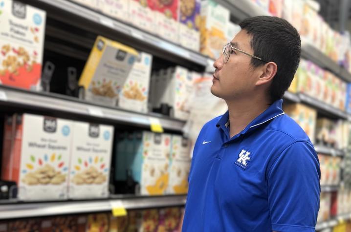 Shuoli Zhao looking at cereals in a grocery store.
