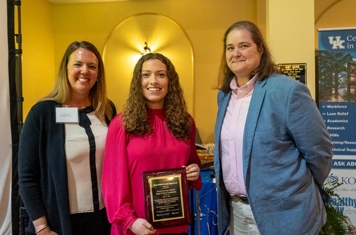 students holding an award