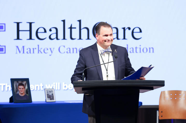 John D'Orazio speaking at a podium.