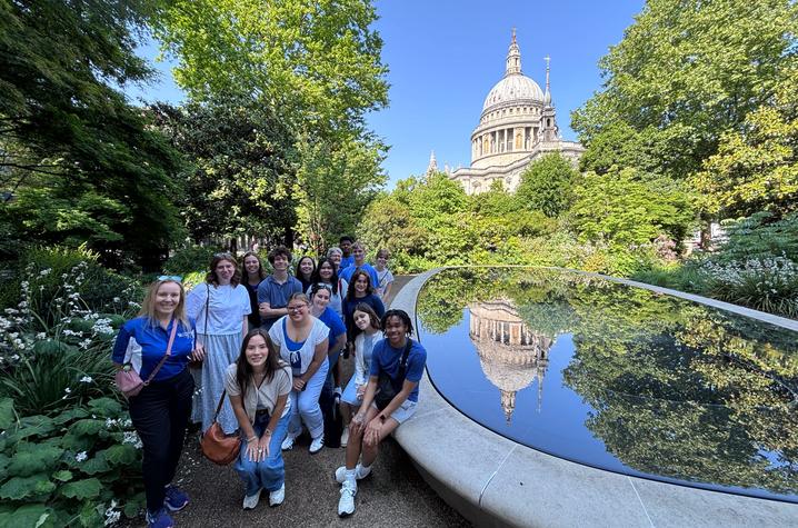 Students stand near a pool in front St. Paul’s Cathedral in London, England