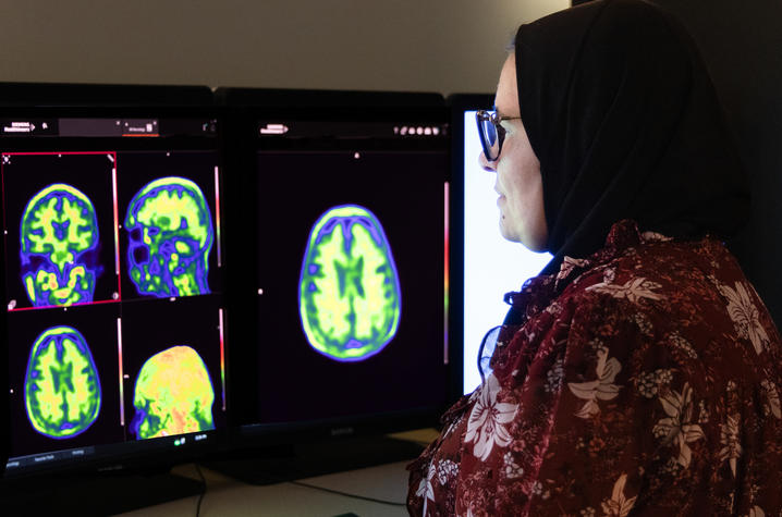 Radiologist Riham El Khouli, M.D, looking at brain scans on a screen
