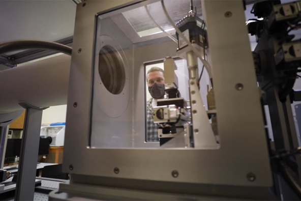 A researcher in the Electron Microscopy and Materials Characterization Core loads a sample for testing into the small angle X-ray scattering system designed to study materials structure at the nano and meso scale. Photo provided.