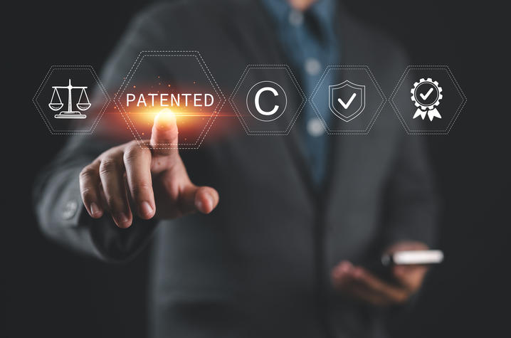 a person pointing to the word "patented"