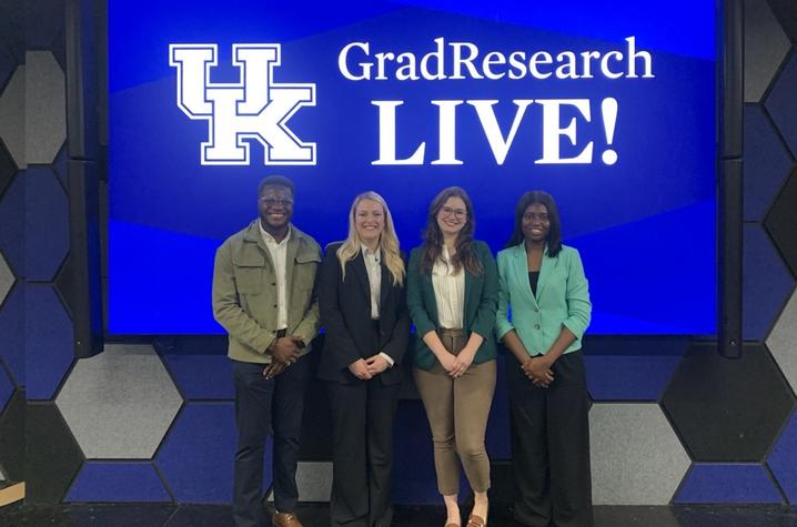 Odianosen Ewah, Courtney Martin, Alyson Ackerman Olivelli and Damilola Petinrin stand in front of the UK GradResearch LIVE! logo