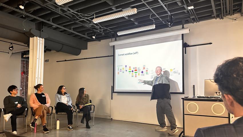attendees watch a presentation on a projector screen