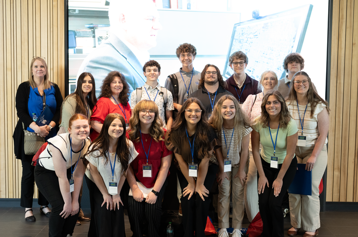 students take a group photo