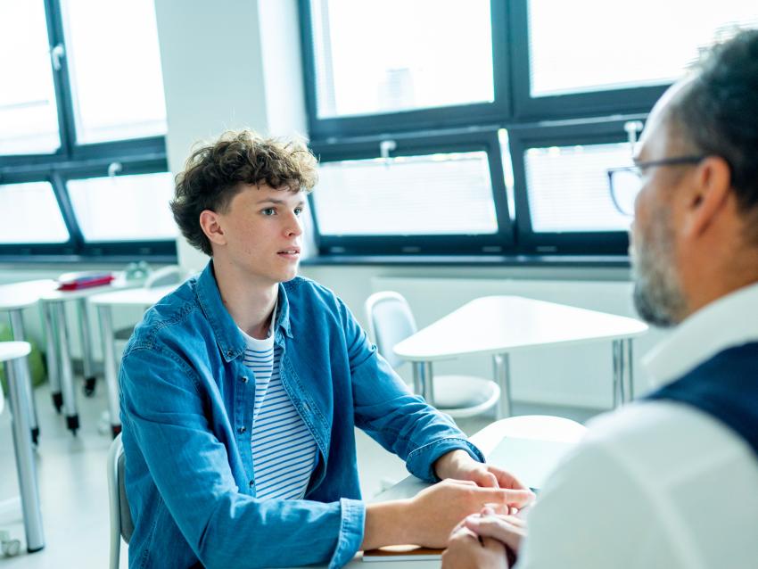 two people having a conversation in an open room.