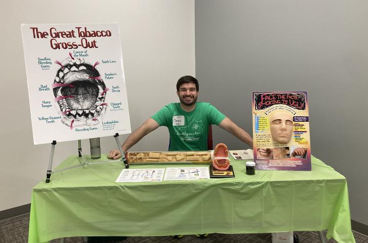 Sean Regnier staffs an informational booth at the Special Olympics.