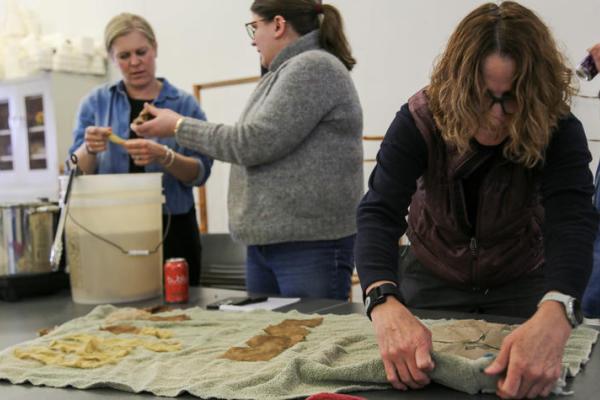 Participants demonstrate natural dyeing in the workshop