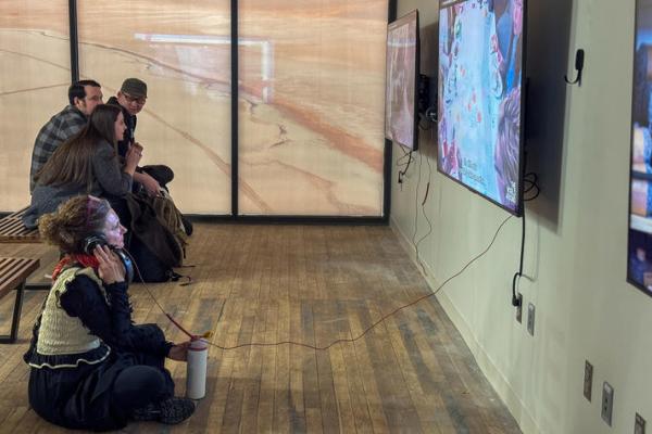 visitors view digital boards in a gallery