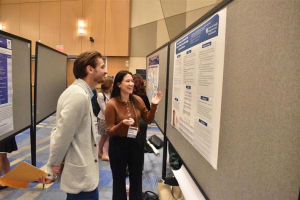 attendees looking at a poster during Markey Research Day
