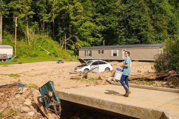 UK Cooperative Extension Agent Dora Centers delivers a bucket of cleaning supplies to residents in Eastern Kentucky affected by flooding.