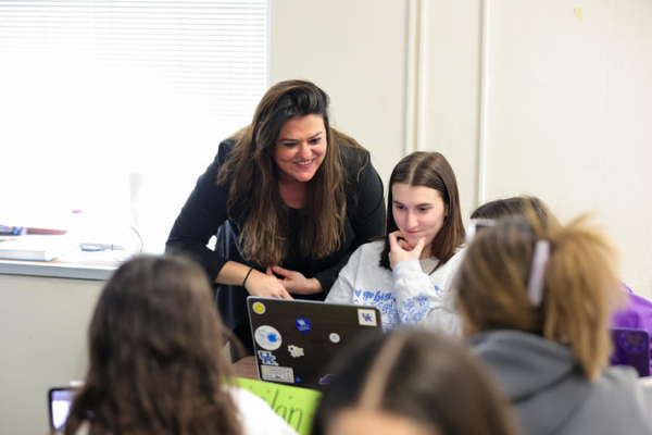 Sahar Alameh works with students in a classroom