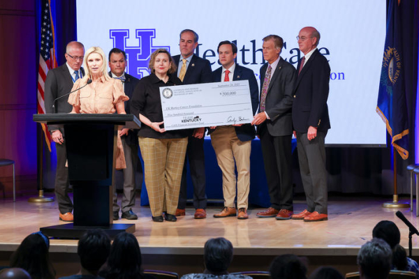 Brittany Beshear speaks as the Kentucky Pediatric Cancer Research Trust Fund presents a check on stage