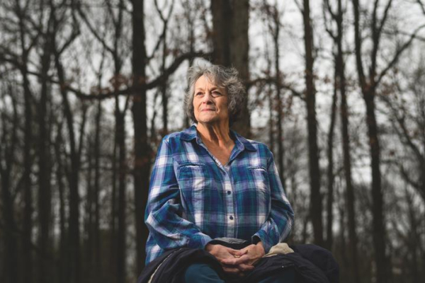 Debra Kantosky sitting the woods