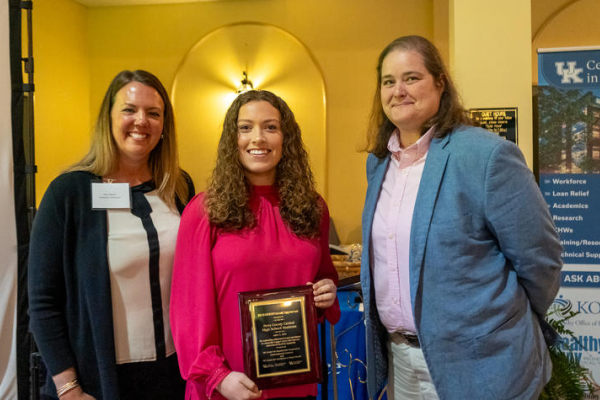 students holding an award