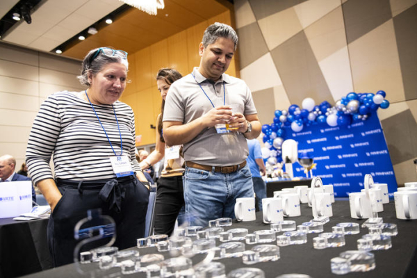 Conference attendees visit a table at the 2025 Patent Palooza!