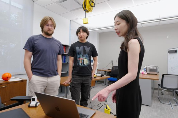 Biyun Xie in a robotics lab with researchers