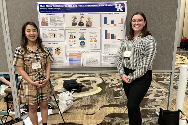 Dr. Chorong Oh and Emily Jones standing in front of a research poster