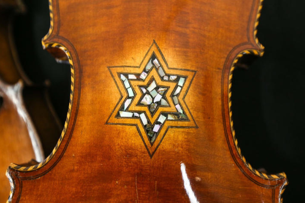 the back of a violin with a decorative inlay of a 6-pointed star