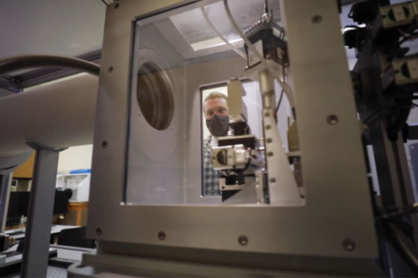 A researcher in the Electron Microscopy and Materials Characterization Core loads a sample for testing into the small angle X-ray scattering system designed to study materials structure at the nano and meso scale. Photo provided.