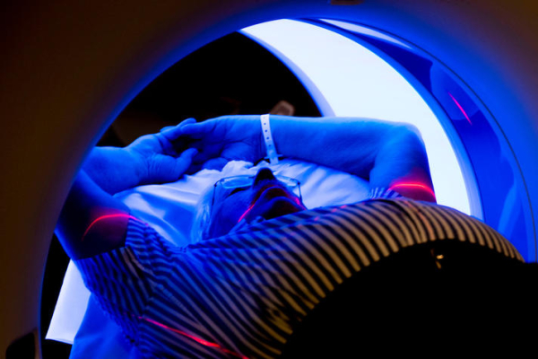 patient lying down, receiving a CT scan