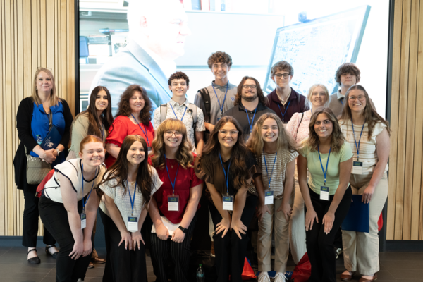 students take a group photo