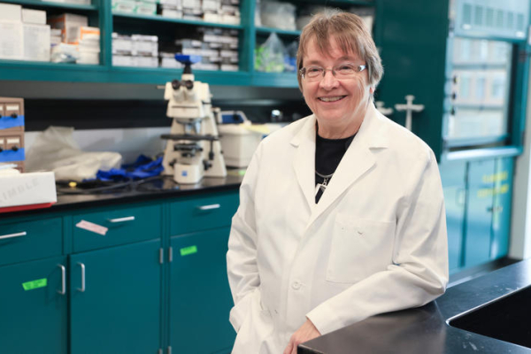 Linda Van Eldik, director of the UK Sanders-Brown Center on Aging, stands in a research laboratory.