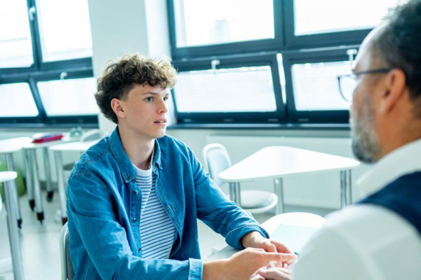 two people having a conversation in an open room.