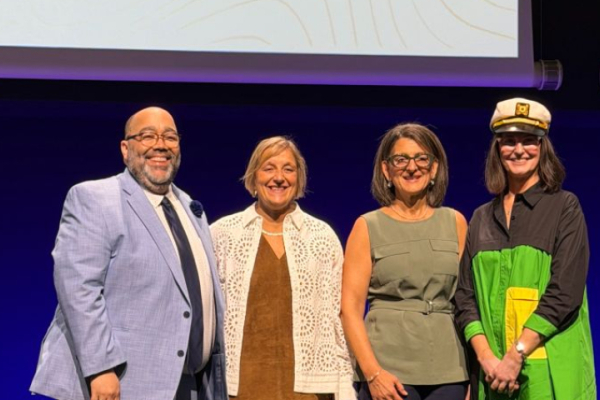 Group photo of Dr. Moga on stage with ISPE leadership