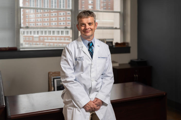 Kenneth Campbell in a white lab coat