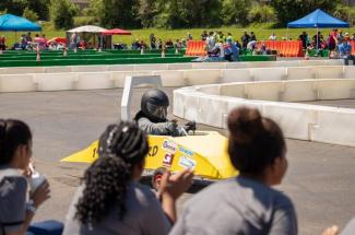 Picture of someone racing a one-person electric vehicle