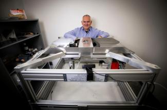 Photo of Brent Seales with lab equipment