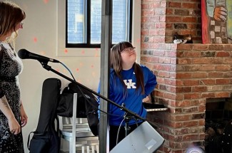 Ann Switzer (center) helps record artists' sets at Kenwick Table's open mic night. Photo by Lindsay Travis.