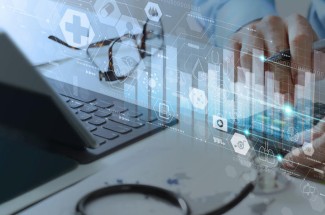 Stock photo of a laptop and icons representing healthcare data