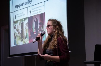 UK arts administration student Kristin Earnest gives a presentation at the 2023 “Fish Tank: Emerging Entrepreneurs in the Arts” pitch competition.