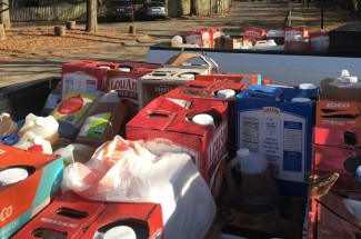 Discarded grease containers in the back of trucks