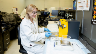 Molly Lobel Conducts research in a lab