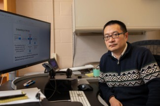 Qing Shao at desk