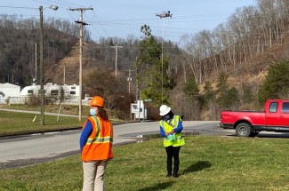 Kentucky Homeplace community health workers Chyna Smith, left, and Carole Frazier retrieve a package delivery from a drone.