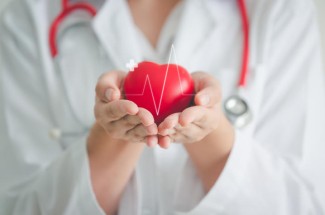 A doctor holding a heart to represent heart health