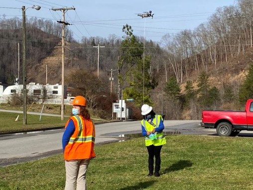 Kentucky Homeplace community health workers Chyna Smith, left, and Carole Frazier retrieve a package delivery from a drone.