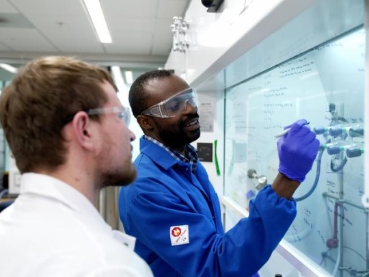 Samuel Awuah, right, works with teaching assistant Justin Holmes in the lab.