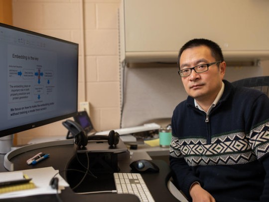 Qing Shao at desk