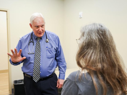 Greg Jicha, M.D., Ph.D., director of clinical trials at UK’s Sanders-Brown Center on Aging, conducts an exam.