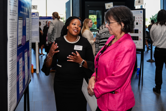 Yolanda Jackson, College of Communication and Information Ph.D. student, shares her Alzheimer’s screening research with NIH Director Monica Bertagnolli.