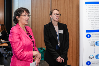 NIH Director Monica Bertagnolli talks with Surgery Resident Hannah McDonald about preliminary results of a clinical trial run by Dr. Prakash Pandalai comparing two different doses of a standard chemotherapy used for metastatic GI cancers.